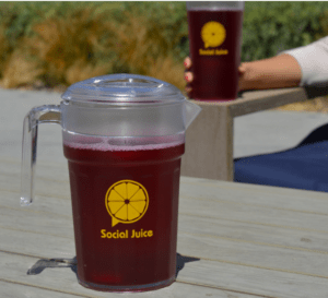 A photo showing a custom logo on a drink pitcher outside on a table