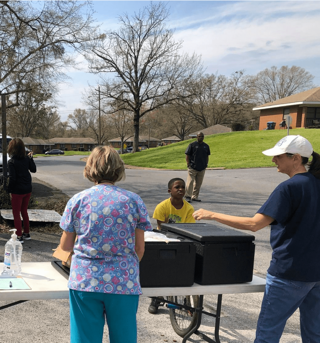 Woman passing out meals at school
